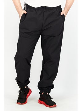 Buy Men Sportswear Fit Tape Woven Track Pants, Black in UAE