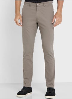 اشتري Men Grey Solid Mid-Rise Regular Trousers في الامارات