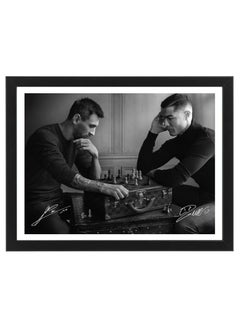 Buy Lionel Messi and Cristiano Ronaldo Playing Chess Poster with Frame 30x40cm in UAE