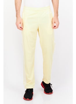 Buy Men Sportswear fit Embroidered Logo Outdoor Track Pants, Yellow in UAE