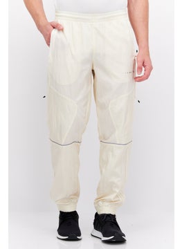 Buy Men Sportswear Fit Training Track Pants, Off White in UAE