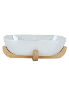 Buy Deep oval beige porcelain serving bowl with a wooden base in UAE