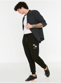 Buy Black Regular Cut Elastic Leg Lace Up Text Printed Sweatpants TMNSS22EA0150 in Egypt