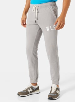 Buy Eco-Friendly Essential Slogan Sweatpants Light Grey in UAE