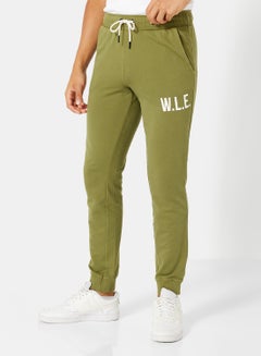 Buy Eco-Friendly Essential Slogan Sweatpants Olive in UAE