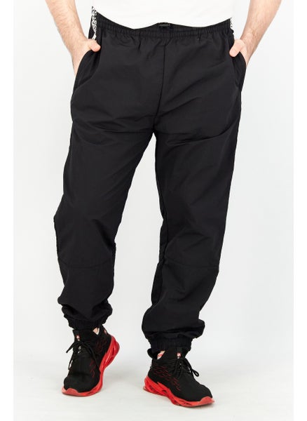 اشتري Men Sportswear Fit Tape Woven Track Pants, Black في الامارات