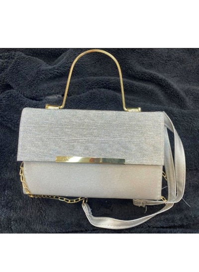 Buy A luxurious women's bag in silver color with a golden metal handle in Egypt