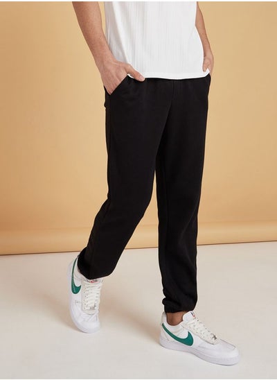 اشتري Elasticated Waist Regular Fit Jog Pants with Faux Fly and Cuffed Hem في السعودية