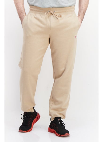 Buy Men Sportswear Fit Brand Logo Outdoor Jogger Pants, Tan in UAE