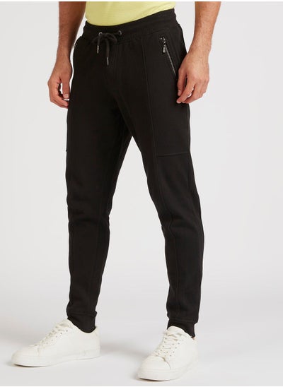 Buy Iconic Solid Joggers with Drawstring Closure and Pockets in Saudi Arabia