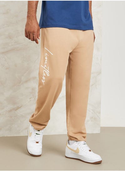 Buy Slogan Print Oversized Jogger with Drawcord Detail in Saudi Arabia