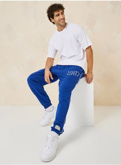 Buy Relaxed Fit Terry Jogger with Piping Detail in Saudi Arabia