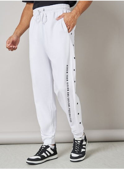 Buy Oversized Side Vertical Print and Popper Detail Joggers in Saudi Arabia