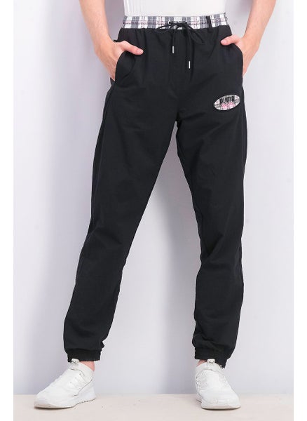 Buy Men Regular Fit Solid Brand Logo Pants, Black in Saudi Arabia