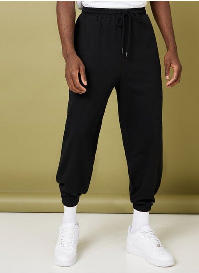 Buy Solid Oversized Fit Elastic Cuff Jogger in Saudi Arabia