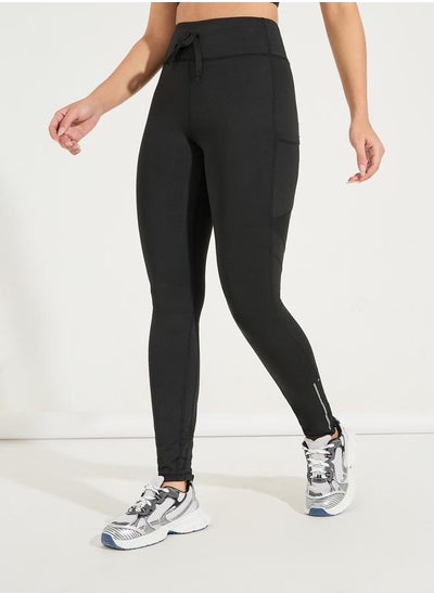 Buy Reflective Ankle Zip Detail Side Pocket Leggings in Saudi Arabia