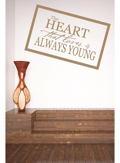 اشتري ملصق حائط بتصميم عبارة The Heart That Loves Is Always Young بيج 50x31 سنتيمتر في الامارات