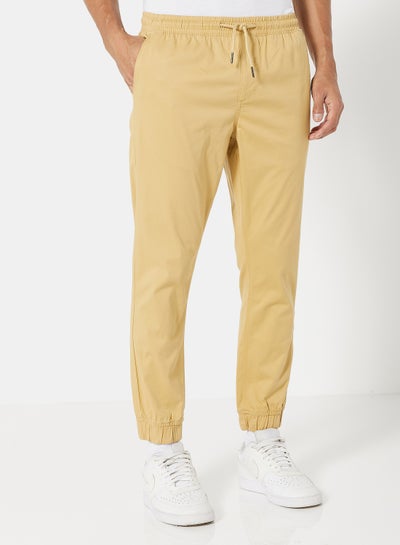 Buy Solid Pattern Premium Joggers Beige in UAE